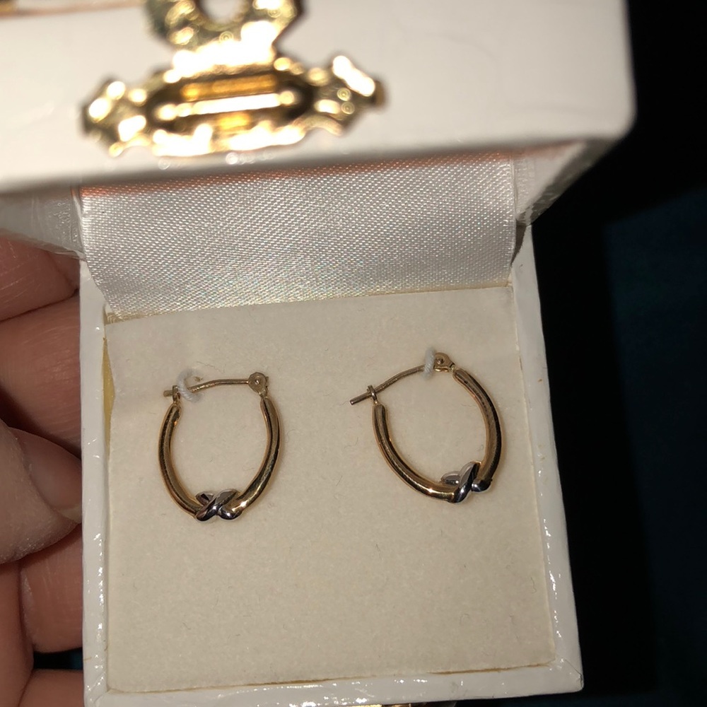 Small gold hoop earrings with silver x design